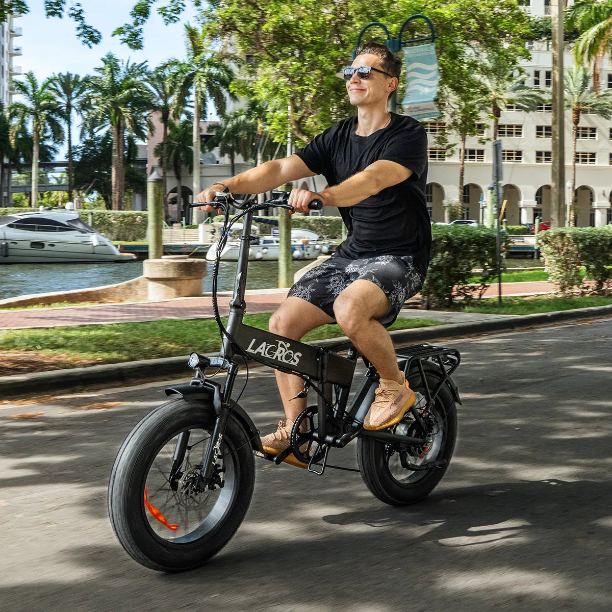 Riding a black Pinecone electric bike on a city street